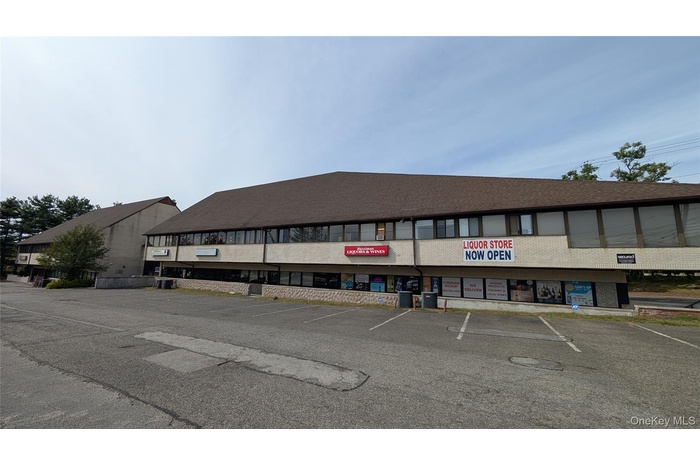 View of property featuring uncovered parking