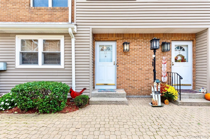 View of exterior entry with brick siding