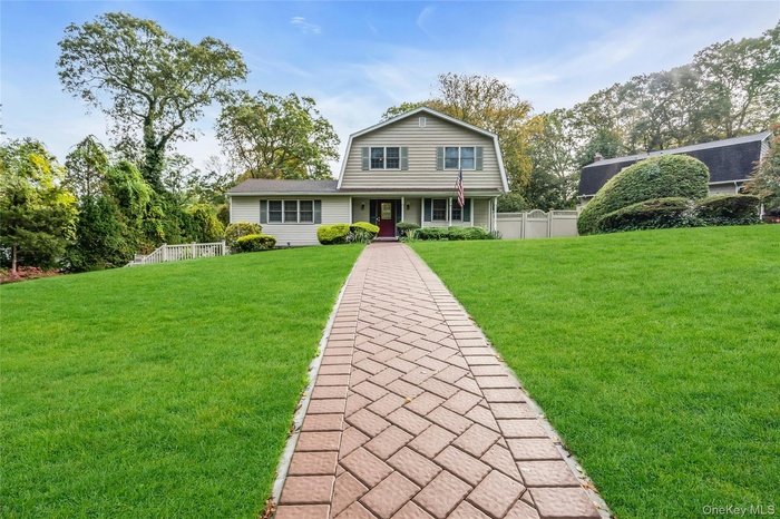 Colonial inspired home featuring a gambrel roof