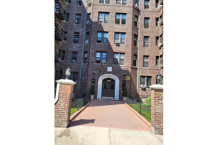 View of apartment building / complex featuring cooling unit