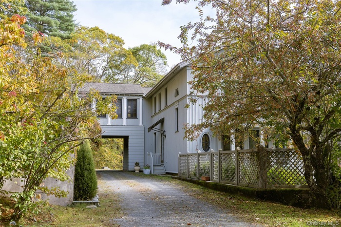 View of front of house with driveway and a carport