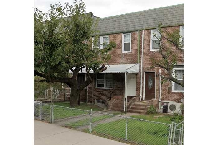 View of front of property featuring a gate and a fenced front yard