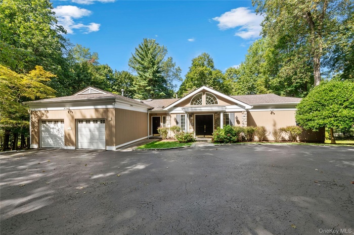 Ranch-style house with a garage and driveway