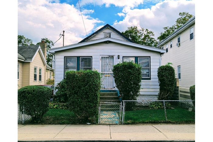 View of front of home with a gate and a fenced front yard