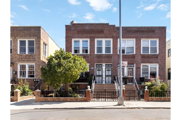 View of front of property with a fenced front yard and brick siding