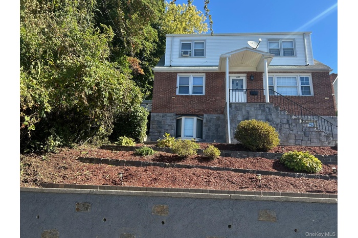 View of front of home featuring brick siding
