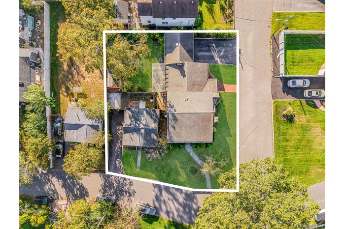 Aerial view of residential area with property parcel outlined