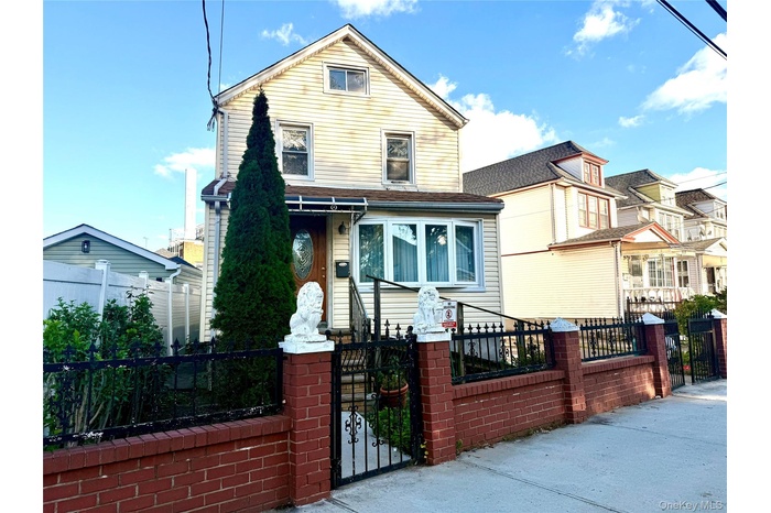 View of front facade with a gate and a fenced front yard