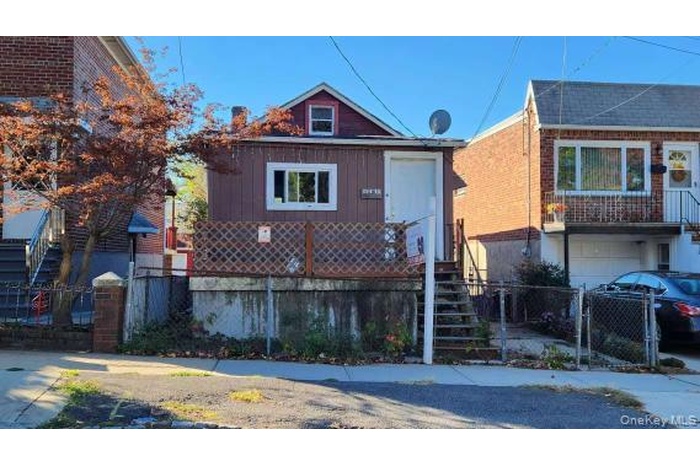 View of front of home featuring a gate and stairs