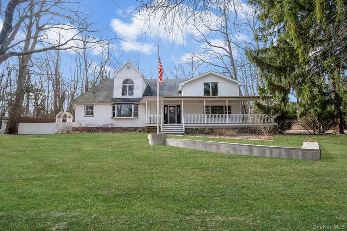 View of front of house featuring a porch and roof with shingles