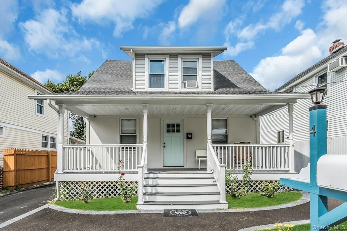 Bungalow-style home featuring a shingled roof and a porch