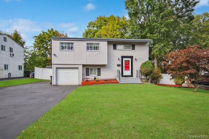 View of front of house with driveway and a garage