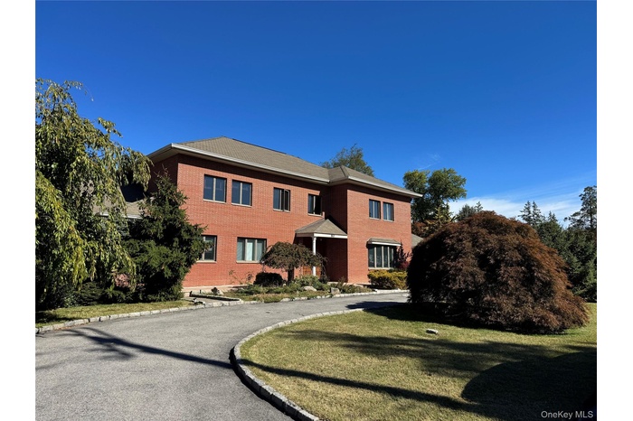 View of front of house with brick siding and a front yard