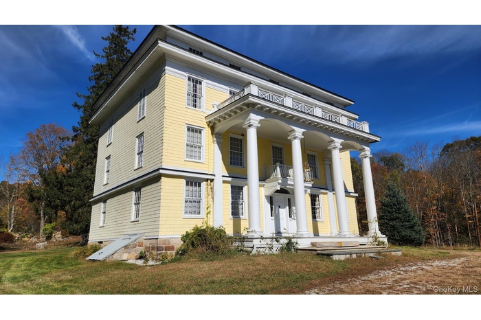 Neoclassical / greek revival house with a porch and a front yard