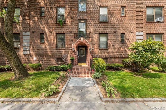 View of front of property with brick siding and a front lawn