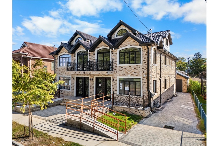 French provincial home featuring brick siding