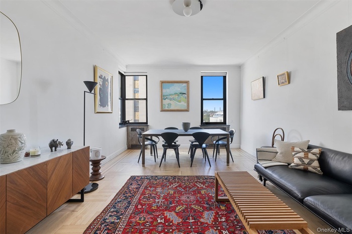 Dining area with ornamental molding and baseboards