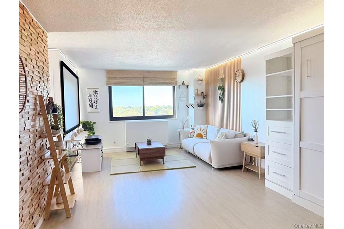 Living room with a textured ceiling and wood finished floors