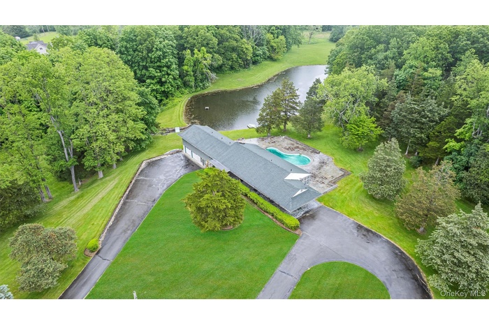 Aerial view of property's location with a large body of water and a pool