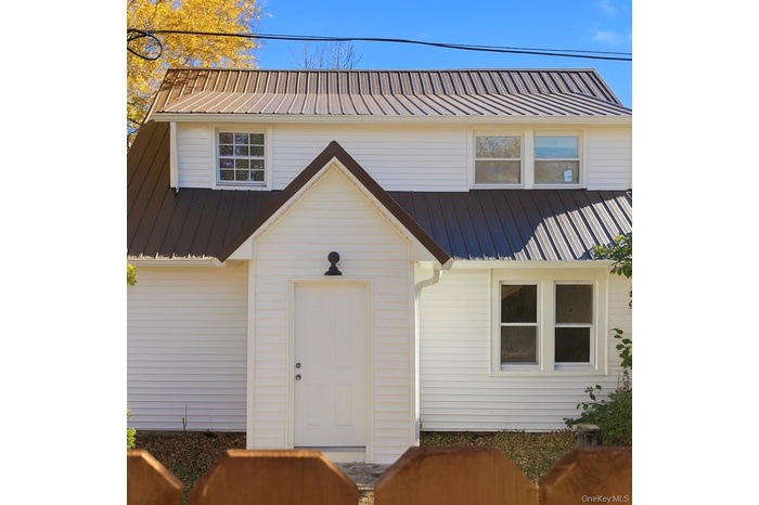 View of front facade featuring a metal roof