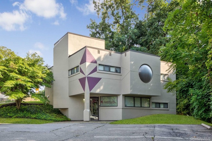 View of property with uncovered parking