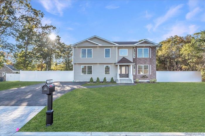 View of front of house with decorative driveway