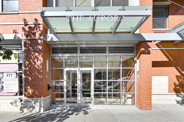 Property entrance featuring brick siding and french doors