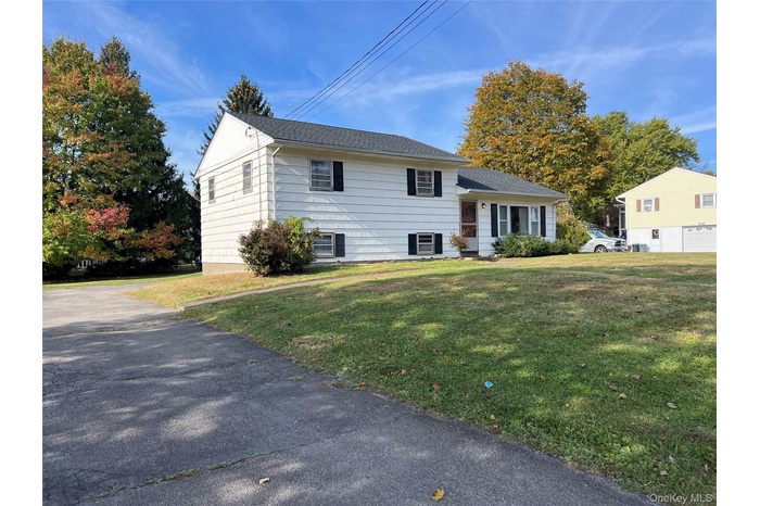 Tri-level home with a front yard