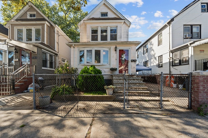 View of front of home with a gate and a fenced front yard