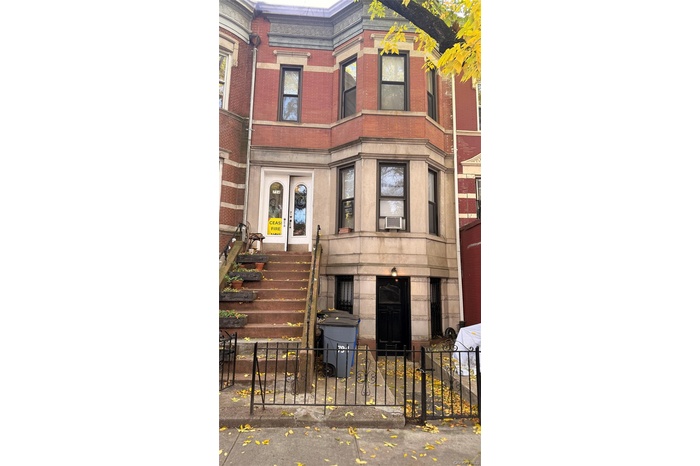 View of building exterior with a fenced front yard