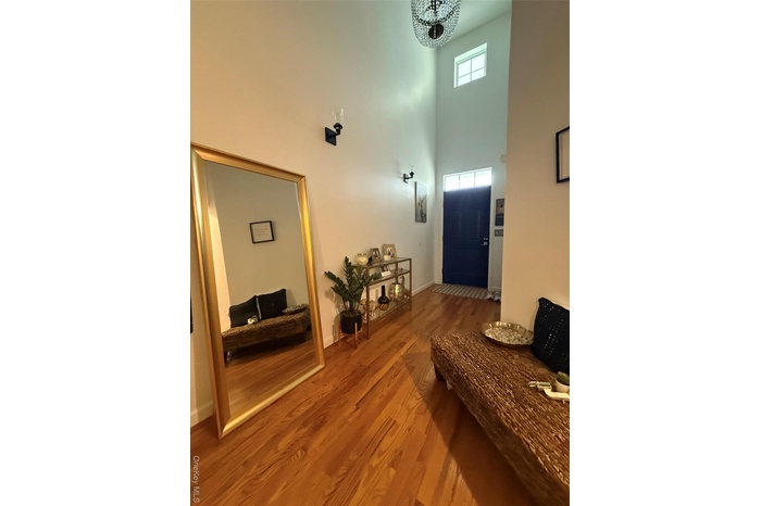 Foyer entrance with a high ceiling and wood finished floors