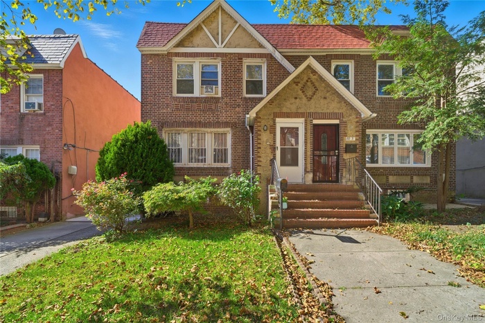 English style home featuring brick siding