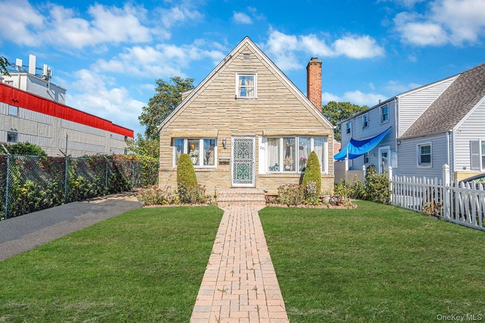 View of front of home featuring a chimney
