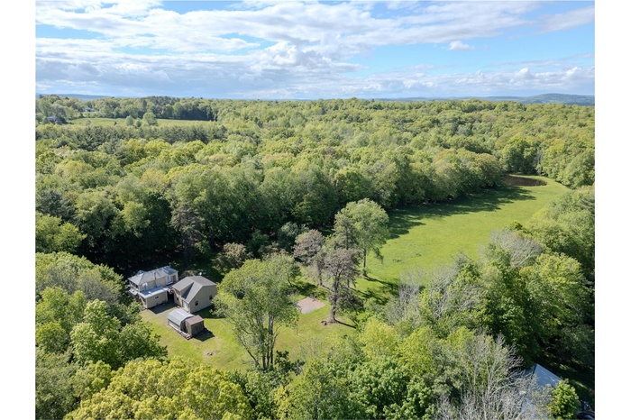View from above of property featuring a heavily wooded area