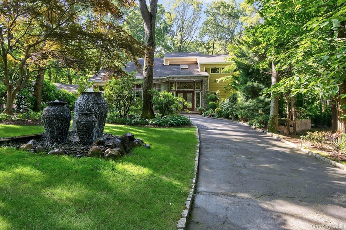 Front view of house with custom urn pondless water feature