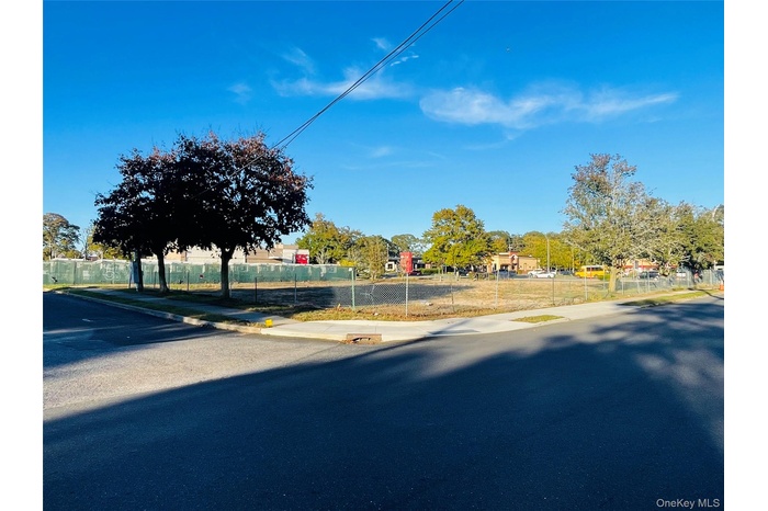 View of asphalt road with sidewalks and curbs