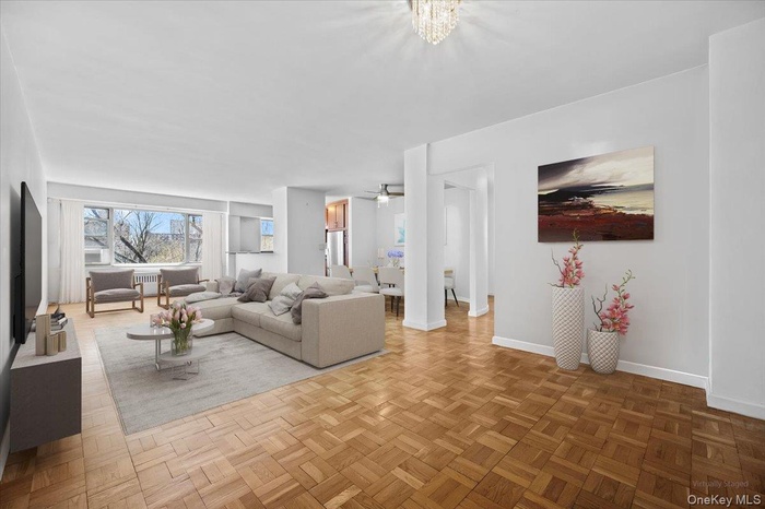 Living room featuring baseboards and radiator heating unit