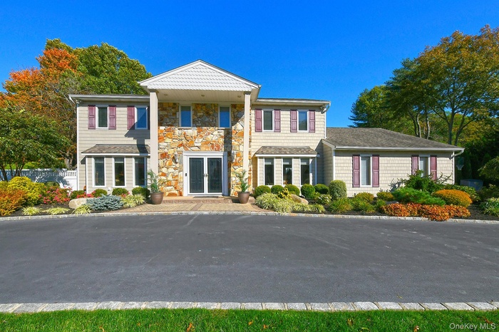 View of front of house with french doors and stone siding
