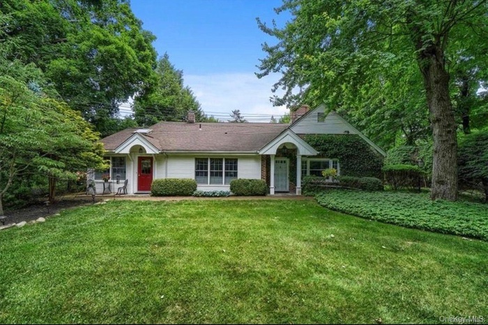 Single story home featuring a front yard and a chimney