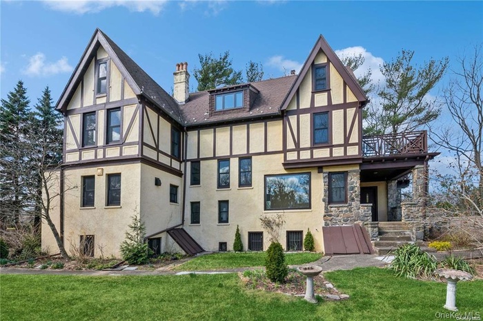 Back of property featuring a lawn