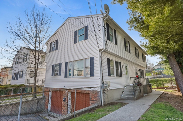 View of front facade featuring fence private yard