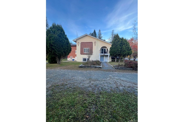 View of front of property with stucco siding and a front lawn