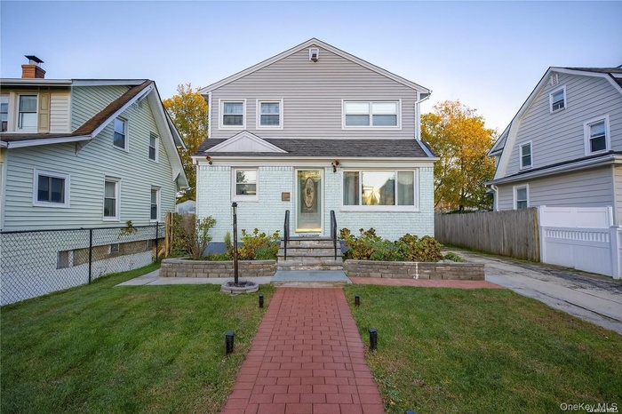 View of front of house featuring brick siding