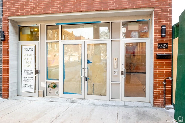 View of exterior entry featuring brick siding