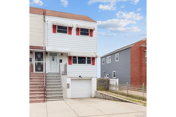 View of front of home featuring roof with shingles, concrete driveway, and a garage