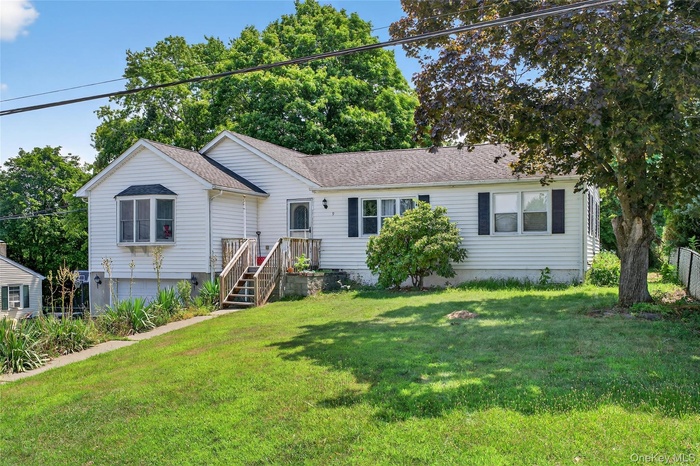 Single story home with roof with shingles and a front yard