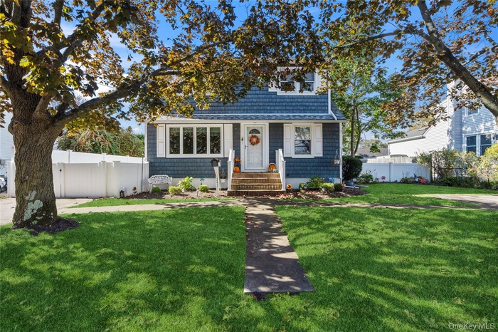 View of front of home featuring a shingled roof