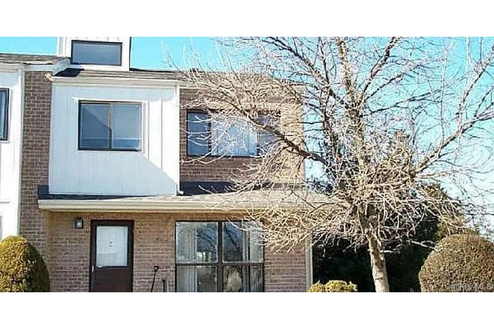 View of property exterior with brick siding