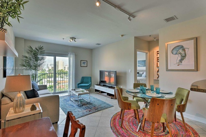 Bright and spacious living area with skyline views of Coral Gables — filled with natural light.