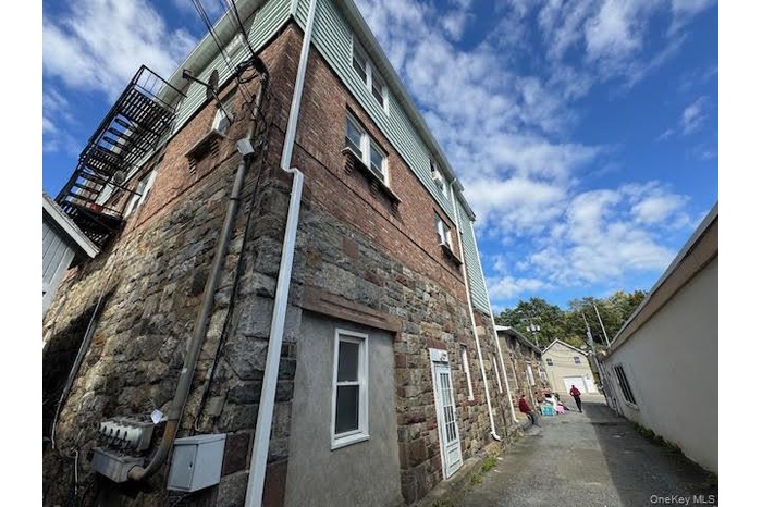 View of side of property featuring stone siding